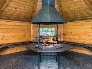 A wood-burning stove in a log cabin with a chimney. - Vacation home 7734 by Interhome (Sulkava)