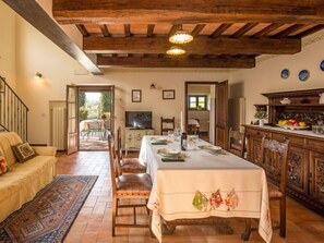 Enjoy meals in this cozy dining area with a long table and comfortable seating for all.