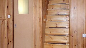 A wooden staircase with a door at the top.