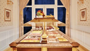 A buffet setup with various food items and a decorative centerpiece.