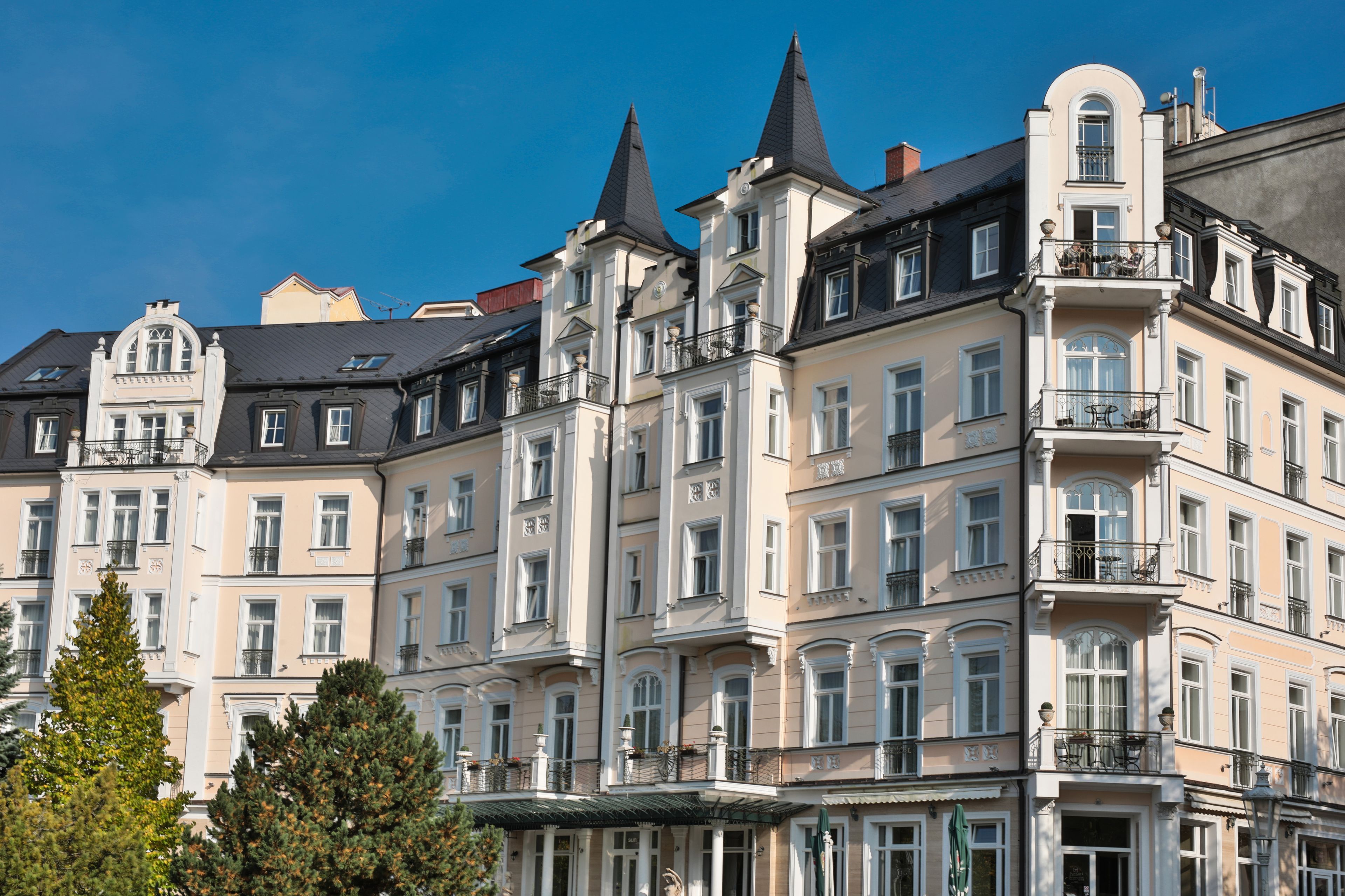 A multi-story building with a classic architectural style, featuring balconies and large windows.