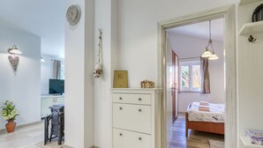 Ein modernes Schlafzimmer mit Bett, Nachttisch und Blick ins Freie.