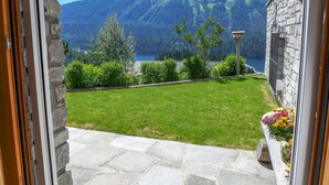 A stone building with a view of a mountain and a lake. - Chesa Sül Muot by Interhome (St. Moritz)
