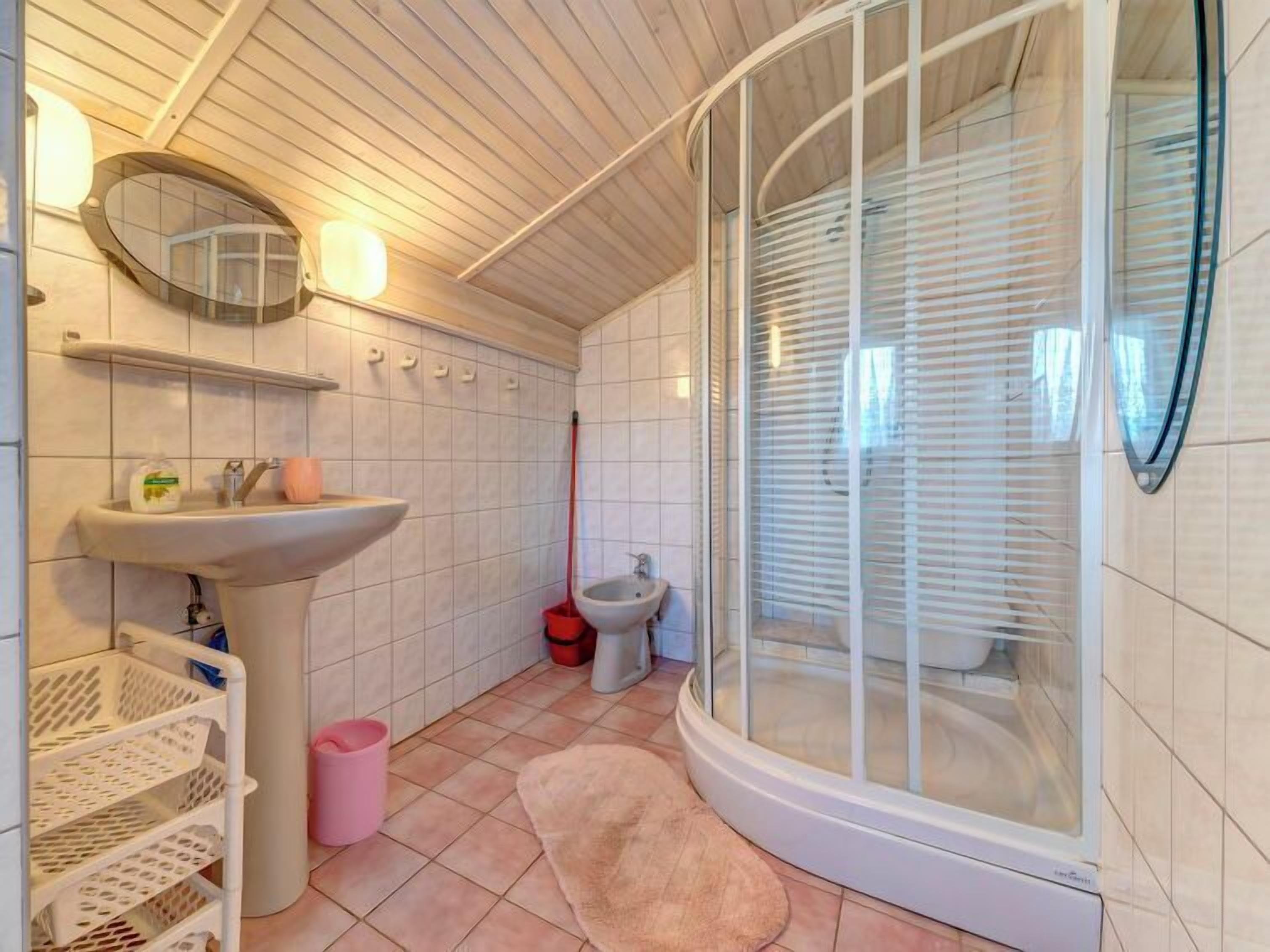 A bathroom with a shower, sink, and toilet.