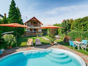 A two-story house with a swimming pool, outdoor furniture, and a garden. - Flamingo by Interhome (Balatonalmadi)