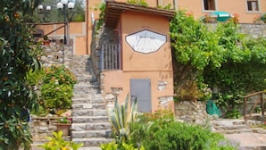 A stone staircase leading to a building with a sign that reads "Soleil du Midi." - Vacation home Bruna by Interhome (Massarosa)