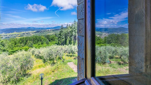 A room with a large window overlooking a lush landscape with trees and distant hills. - Certina 3 by Interhome (Pontassieve)