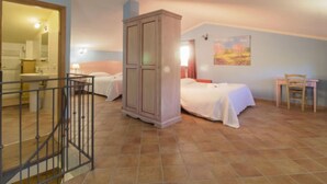 A bedroom with two beds, a wardrobe, a desk, and a chair. - Thermae Villa 36 by Interhome (Pitigliano)
