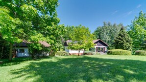 A residential area with multiple houses, well-maintained lawns, and trees. - Marcyporęba by Interhome (Marcyporeba)