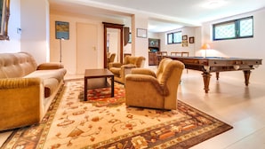 A spacious living room with a pool table, comfortable seating, and a large rug. - Marcyporęba by Interhome (Marcyporeba)