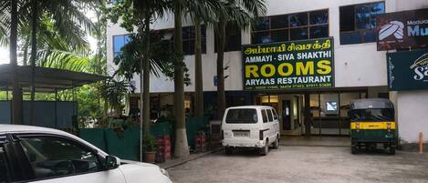 A building with a sign for 'Rooms' and 'Aryaas Restaurant'.