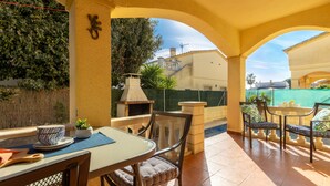A patio area with a table and chairs, a barbecue grill, and a view of a residential area. - Vacation home Sally by Interhome (Deltebre)