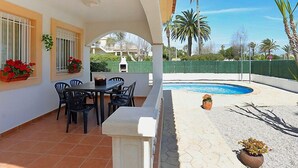A patio with a pool, outdoor seating, and a view of the surrounding area. - Vacation home Vicky by Interhome (Deltebre)