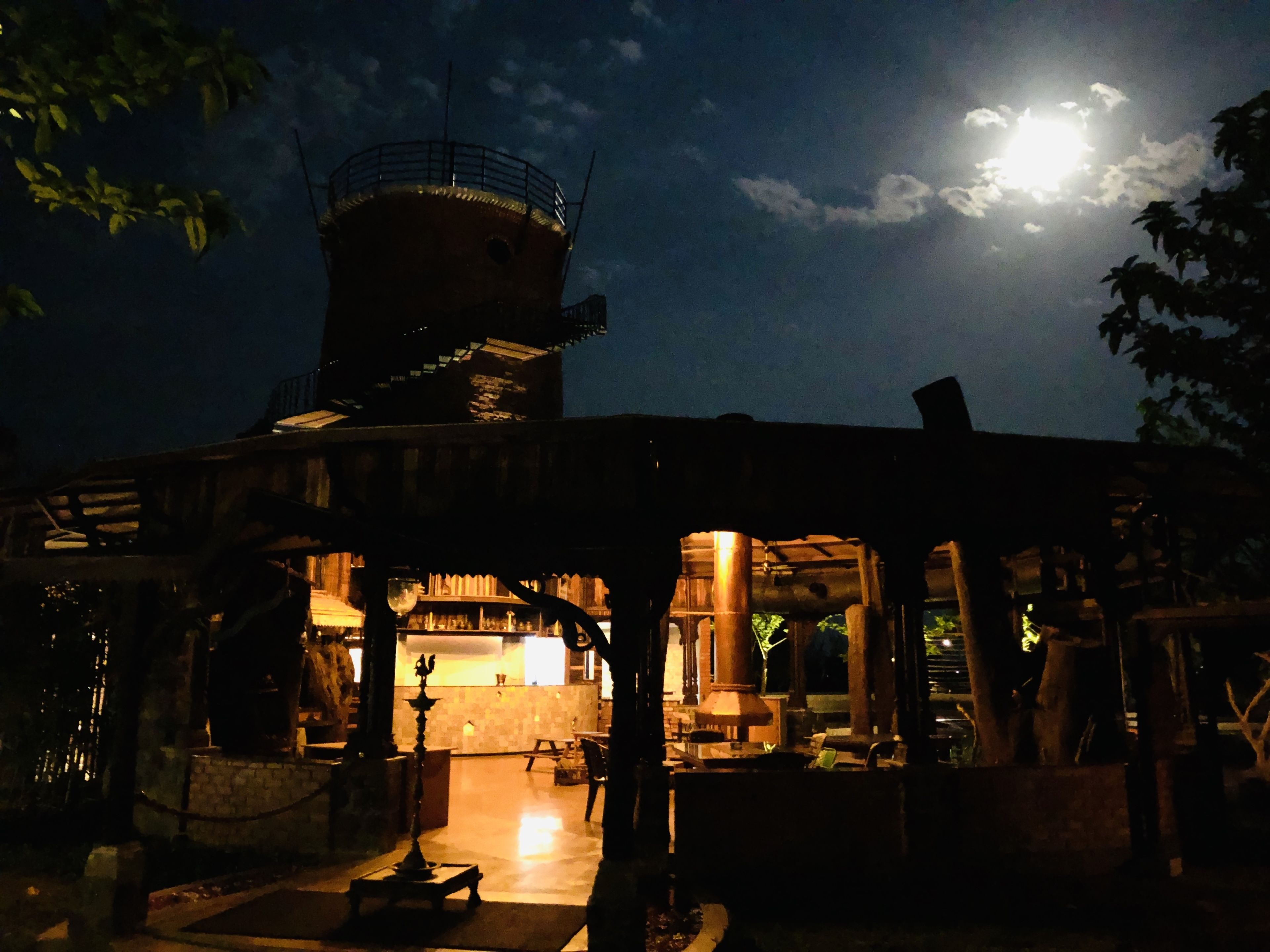 A traditional building with a central courtyard, a water tower, and a bar area.