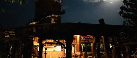 A traditional building with a central courtyard, a water tower, and a bar area.