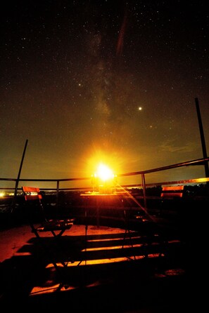 A night sky with stars and a bright sun. - Regenta Resort Aranyaani (Kurai)
