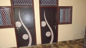 A room with two doors featuring decorative patterns and a tiled floor.