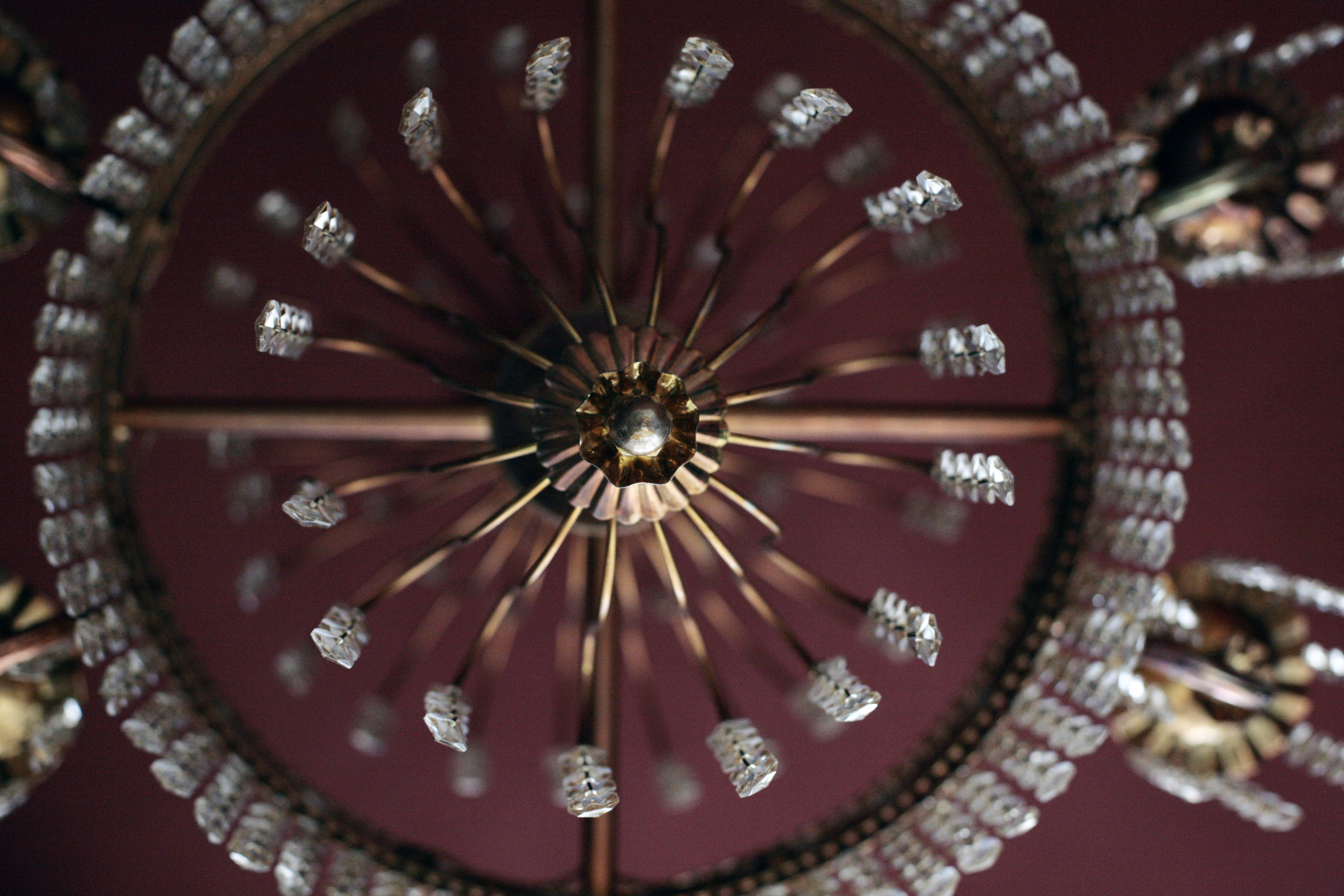 Un candelabro con múltiples detalles de cristal y una estructura metálica central.