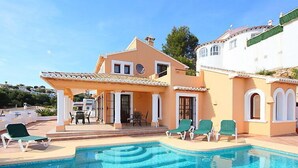 A two-story house with a swimming pool, outdoor seating, and a covered patio area. - Ca Toni by Interhome (Moraira)