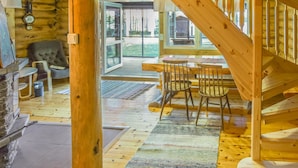 A wooden cabin interior with a staircase leading to a deck area. - Leporanta by Interhome (Kerimäki)