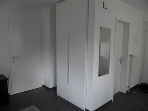 A room with a large wardrobe, a door with a mirror, and a radiator. - Barbara Ost Appartement/Fewo 2-Bettwohnung by Interhome (Engelberg)