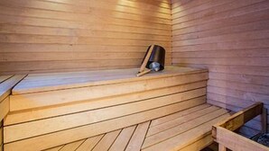 A wooden sauna with benches and a bench seat.