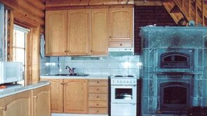 A kitchen with wooden cabinets, a stove, and a built-in oven.
