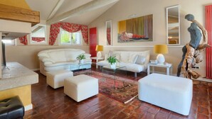 A spacious living room with a high ceiling, white sofas, a coffee table, and a red rug. - Vacation home Moira by Interhome (Umag)