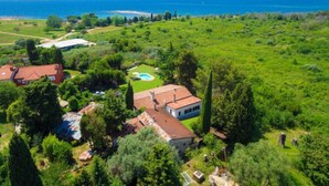 A large estate with multiple buildings, a swimming pool, and expansive green fields. - Vacation home Moira by Interhome (Umag)