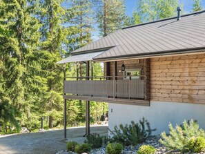 A two-story building with a balcony, surrounded by trees. - Teerenpesä by Interhome (Nilsiä)