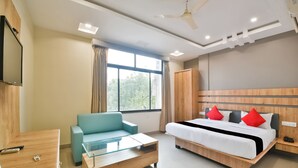A modern hotel room with a bed, a sofa, a TV, and a desk. - Ardency Inn by Park Tree Udaipur (Udaipur)