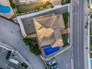 An aerial view of a building with a large swimming pool, a covered outdoor area, and a parking lot. - Colibri by Interhome (Gale)