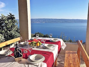 Dine al fresco with a view of the sea and distant hills.