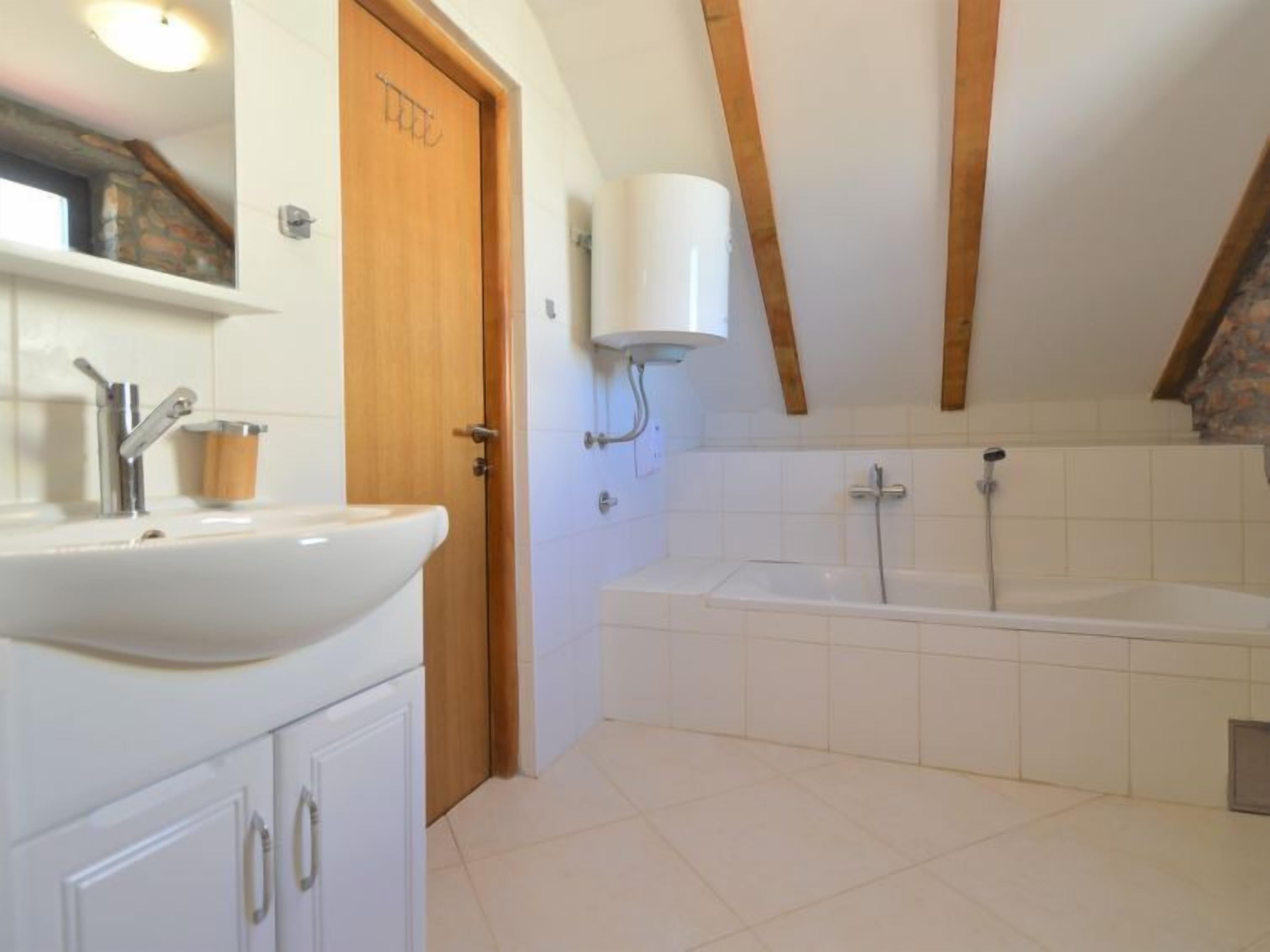 A bathroom with a sink, toilet, and bathtub.