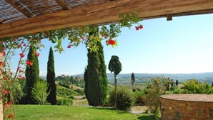 A covered patio with a view of rolling hills and distant buildings. - Podere La Torre by Interhome (Certaldo)