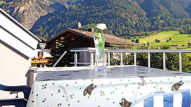 A mountain view with a wooden cabin and a table with a coffee cup design. - Frischmann by Interhome (Umhausen)
