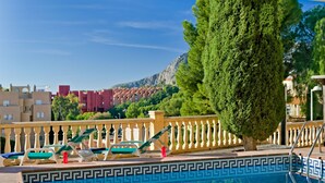 A swimming pool with a tiled border, lounge chairs, and a railing. - Apartment Raquel by Interhome (Calpe/Calp)