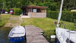 A wooden dock with a small boat moored at the end. - Güstrower Chaussee by Interhome (Krakow am See)