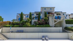 A large, modern building with a swimming pool in front. - Vacation home Nini by Interhome (Buje)