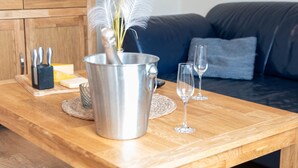 A wooden table with a metal container, a knife block, a cheese block, and two wine glasses. - Strandläufer by Interhome (Norddeich)
