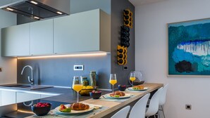 A modern kitchen with a central island, stainless steel appliances, and a minimalist design.