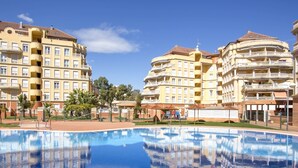 A hotel with multiple balconies, a swimming pool, and a clear blue sky. - Jardines del Montgo by Interhome (Dénia)