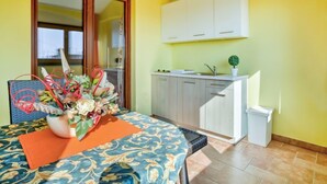 A compact living space with a dining area, kitchenette, and a large window. - Apartment Ulika by Interhome (Poreč/Tar)
