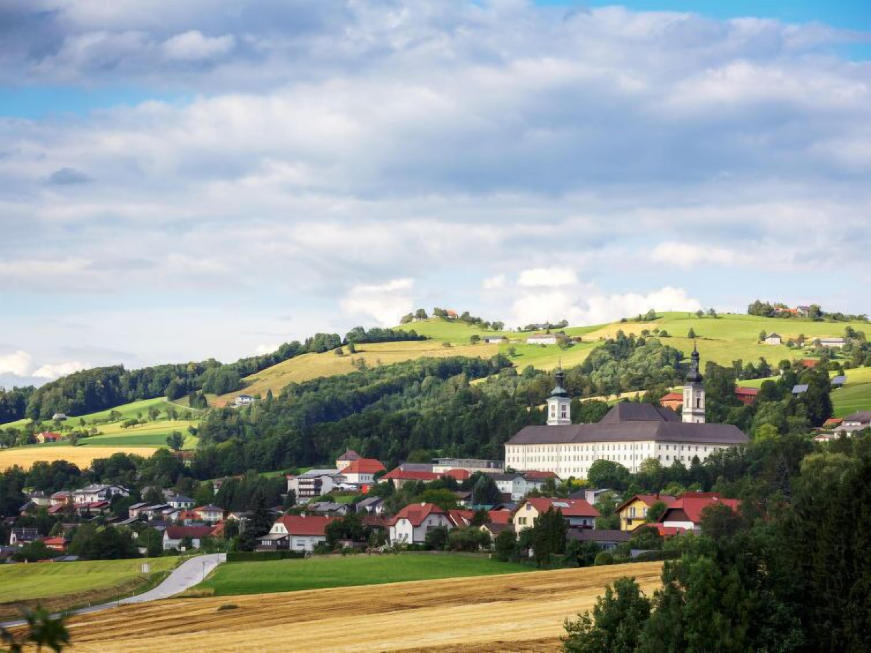 A rural village with a prominent church and residential buildings.