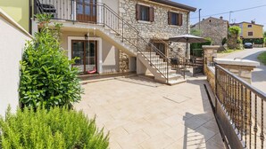 A two-story house with a stone facade, a balcony, and a staircase leading to the upper floor. - Vacation home Darija by Interhome (Novigrad (Istra))