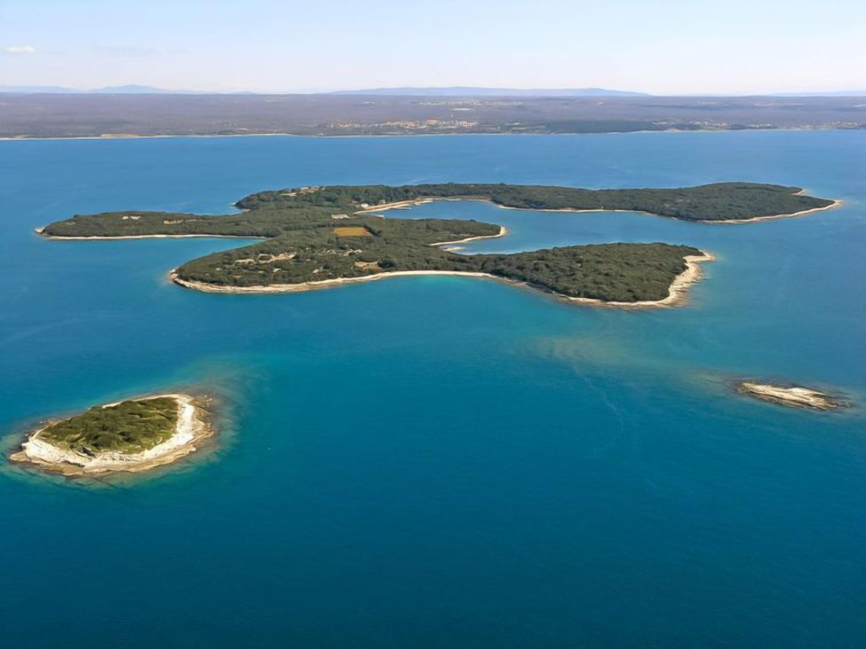An aerial view of a series of interconnected islands with clear blue waters.