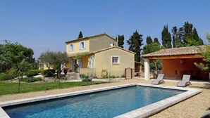 A swimming pool with a clear blue water surface, surrounded by a pebble-lined deck. - Siflora by Interhome (Saint-Rémy-de-Provence)