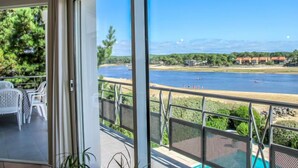 A balcony with a view of a beach and a river. - Les Pinasses by Interhome (Mimizan)