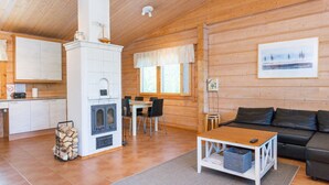 A log cabin interior with a kitchen, dining area, and living room. - Hot pool cottage ainu by Interhome (Enonkoski)