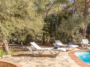 A poolside area with lounge chairs and a swimming pool.